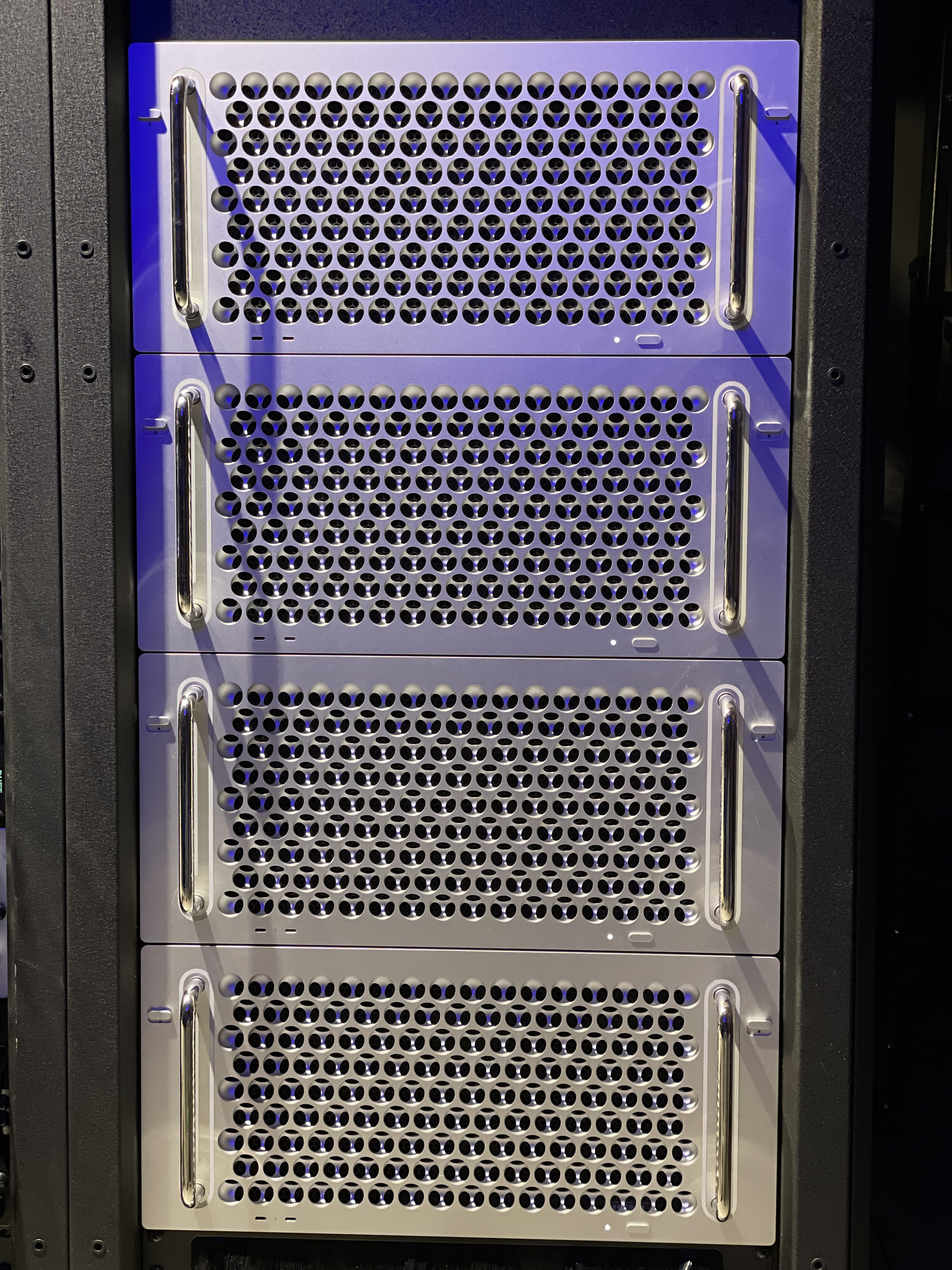 Rack-mounted Mac Pro servers with blue LED lighting